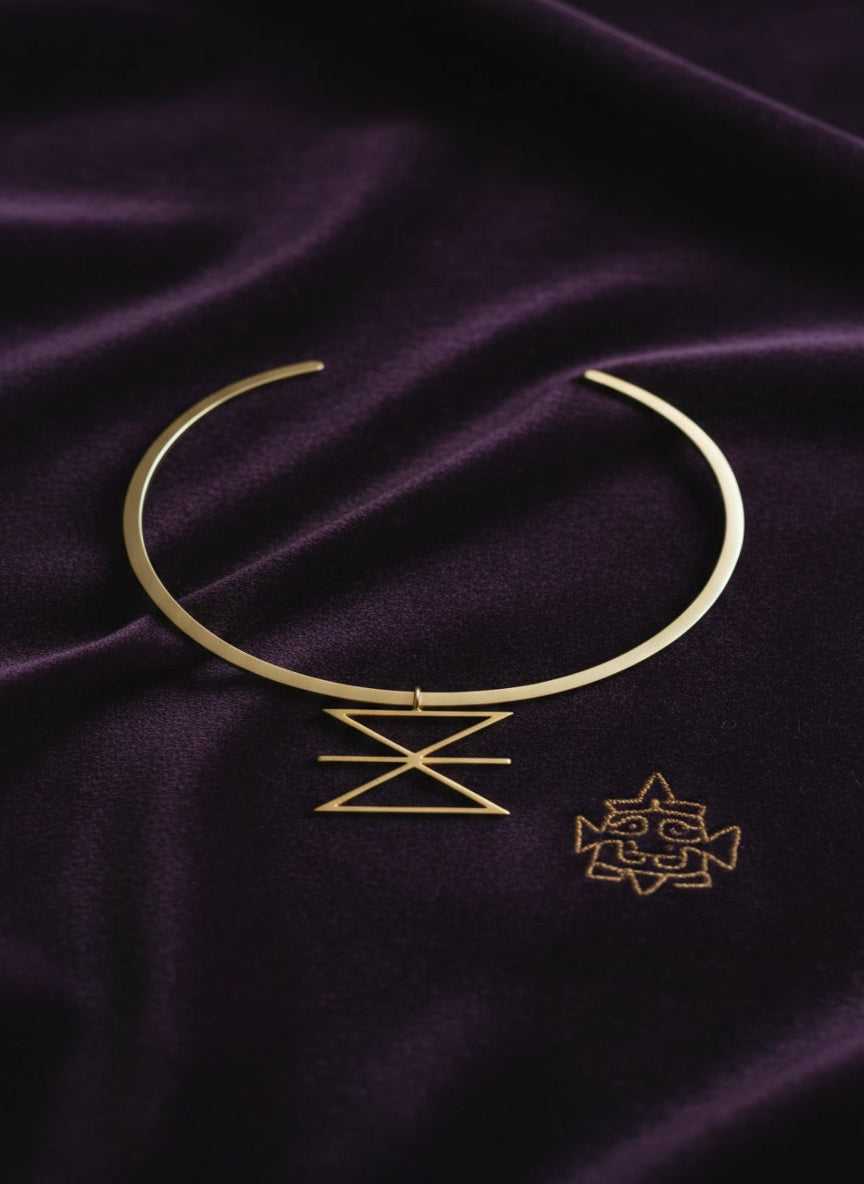 Gold necklace on a purple fabric background